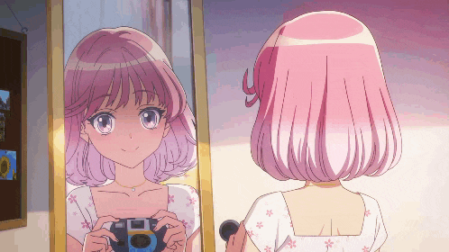 a girl with pink hair is looking at herself in the mirror