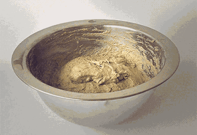 a metal bowl filled with a brown substance