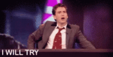 a man in a suit and tie is sitting at a table with the words " i will try " on it