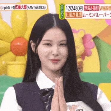 a woman in a white shirt and tie is on a television show