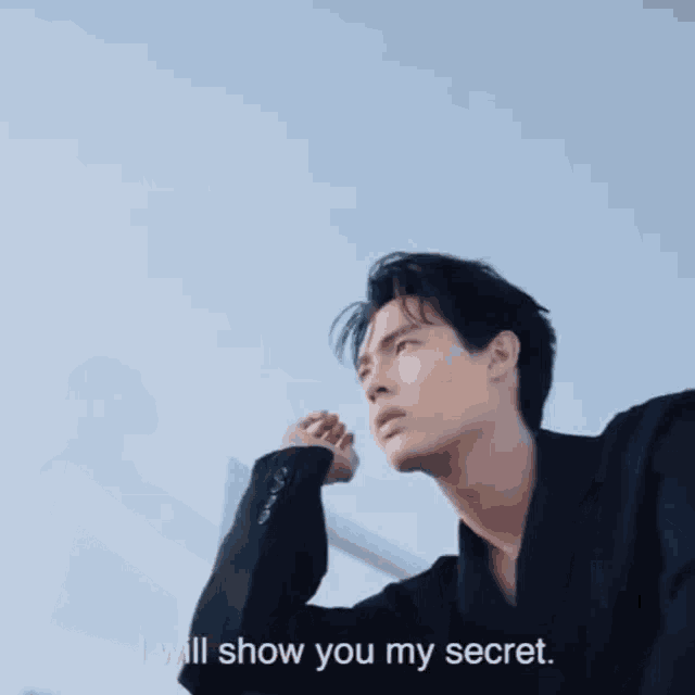 a man in a black jacket says i will show you my secret