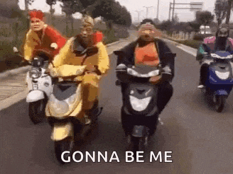 a group of people wearing masks are riding scooters down a street .