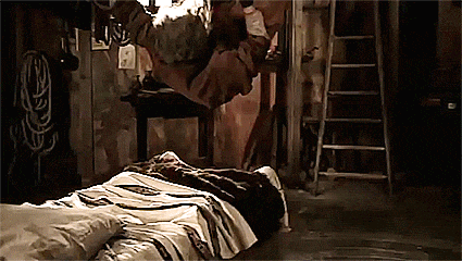 a person is laying on a bed in a dark room