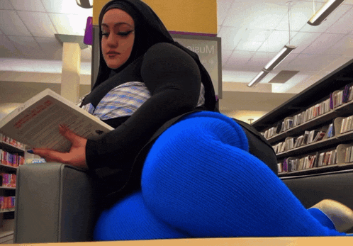 a woman reading a book in a library with a sign that says premium