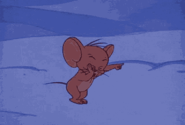 jerry from tom and jerry is standing in the snow and pointing .