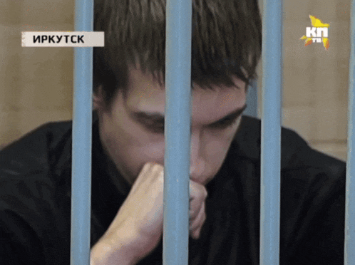 a man behind bars with a kn tv logo on the bottom