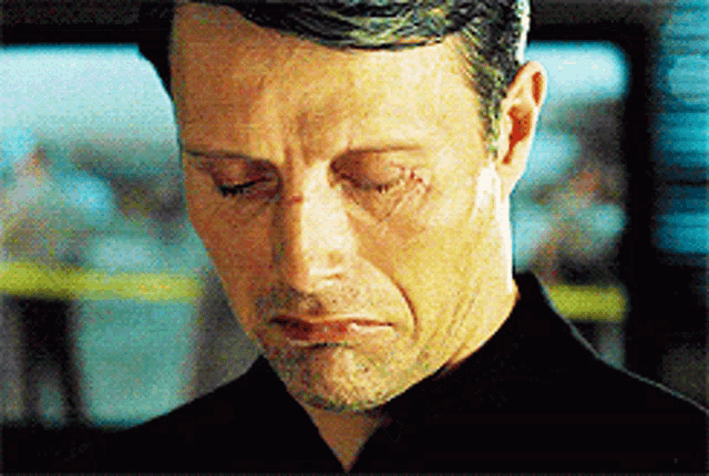 a close up of a man with a scar on his face