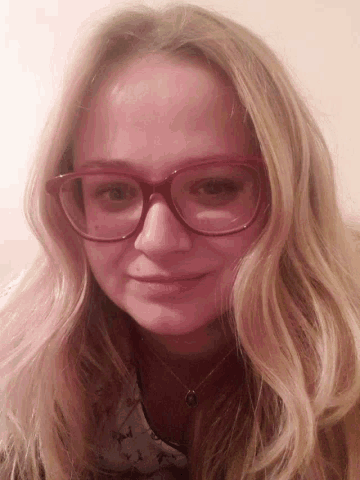 a woman wearing red glasses and a necklace