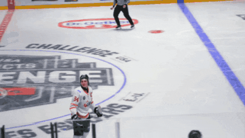a hockey player stands on the ice in front of a challenge logo