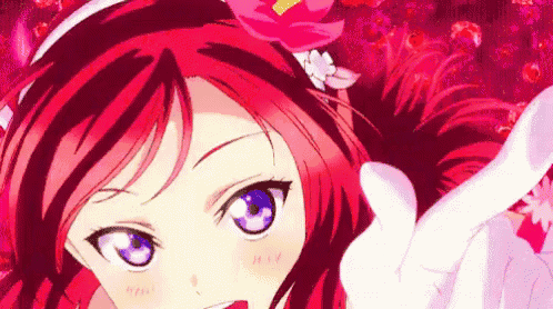 a girl with red hair and blue eyes is wearing a headband with a flower on it .