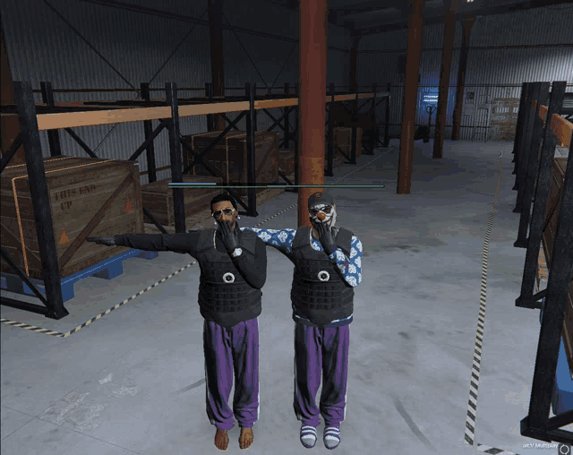 two men are standing in a warehouse with a box that says " this end up " on it