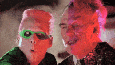 a man and a boy are standing next to each other and the boy is wearing a green mask