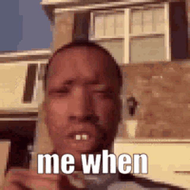 a man is standing in front of a brick building with the words `` me when '' on his face .