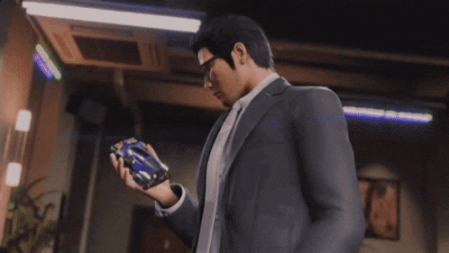 a man wearing glasses and a suit looks down