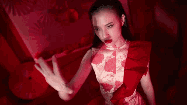 a woman in a red and white dress with red lipstick