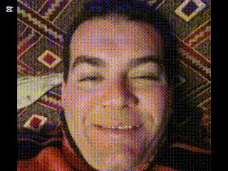 a close up of a man 's face with a patterned background