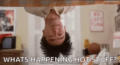 a man is hanging upside down from a ceiling and asking what is happening hot stuff .