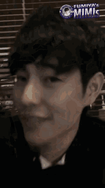 a close up of a man 's face with the words " fumiya 's mimic " on the top