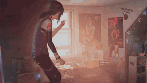 a girl is dancing in a room with posters on the wall including one that says kiss