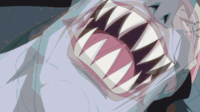 a close up of a shark 's mouth showing the teeth