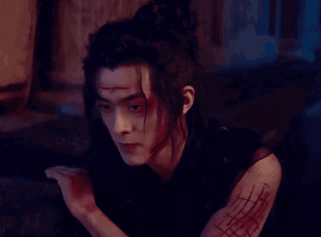 a man with blood coming out of his face and arm