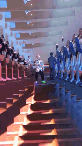 a group of people are standing on stairs in a church