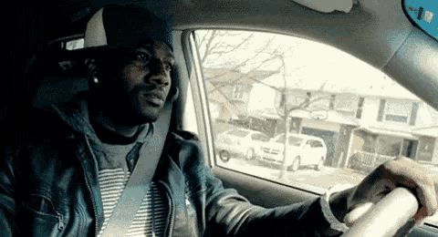 a man in a car looking out the window