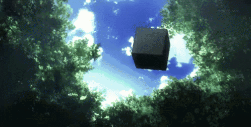 a black cube is floating in the air above a forest