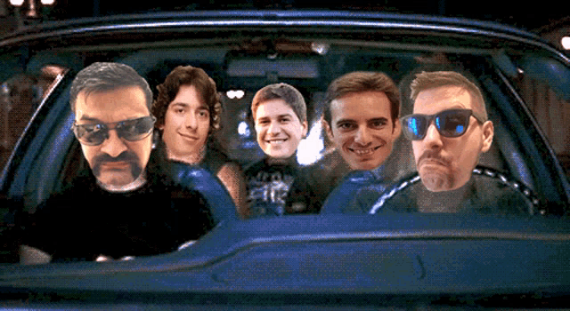 a group of men are sitting in a car with their faces on the window