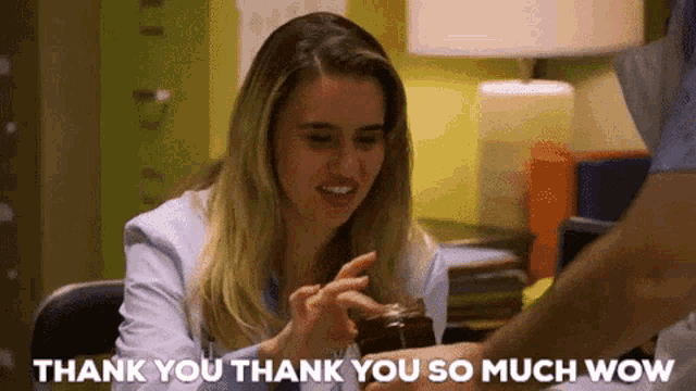 a woman in a lab coat is giving a man a jar of jam and saying thank you thank you so much wow .