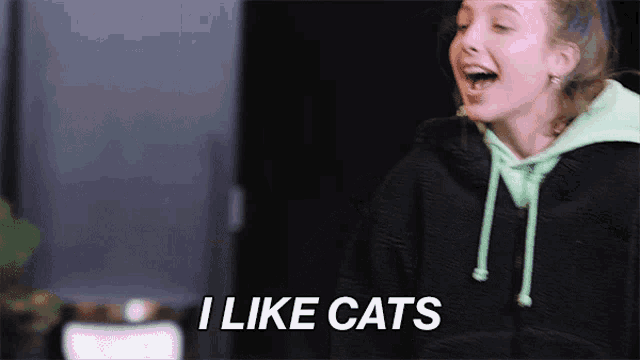 a girl with a green hoodie says i like cats