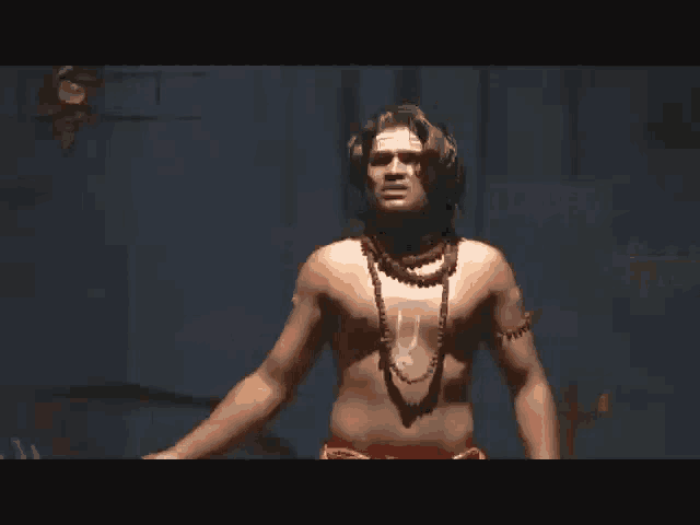 a shirtless man with a necklace around his neck is standing in front of a wall