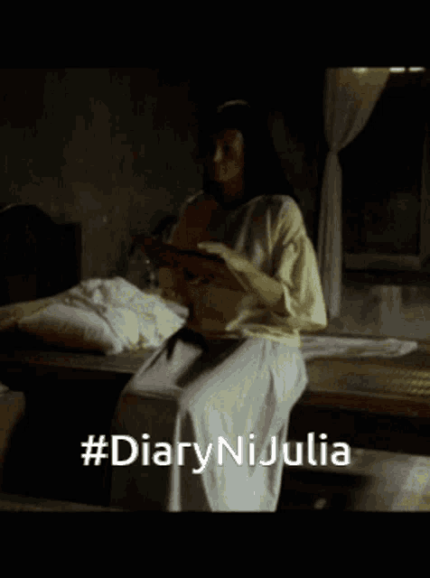 a woman is sitting on a bed reading a book with the hashtag #diarynijulia