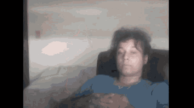 a blurry picture of a woman in a blue shirt