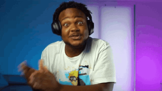 a man wearing headphones and a t-shirt that says ' naruto ' on it