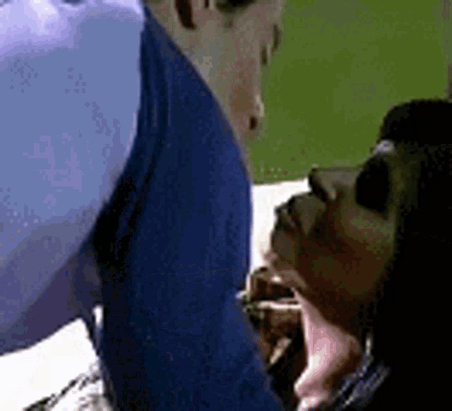 a man and a woman are kissing and the woman is holding the man 's arm .
