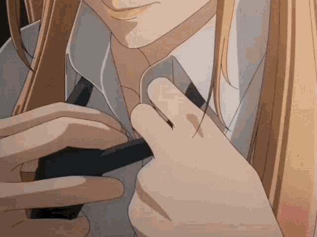 a close up of a person adjusting their shirt and tie