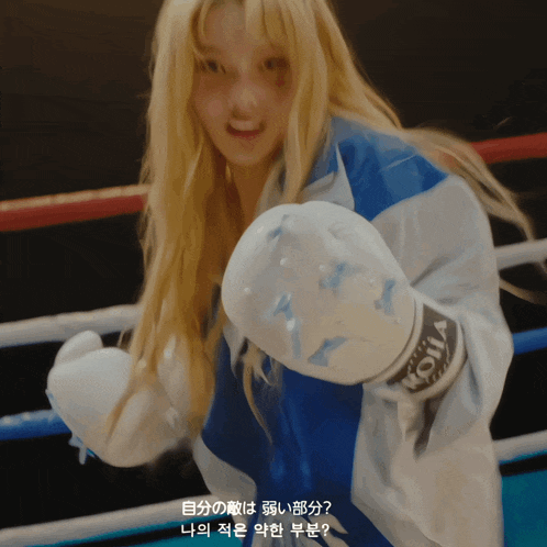 a woman wearing boxing gloves with the letter a on the left hand