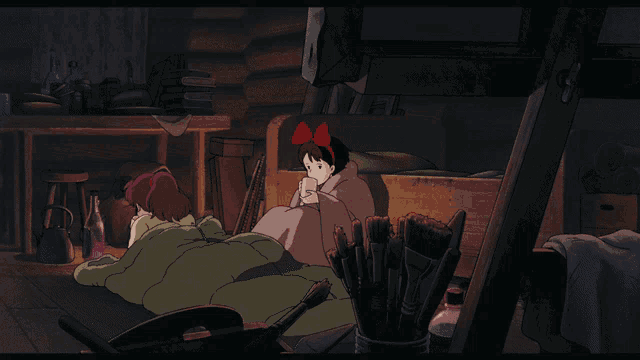 a girl with a red bow on her head sits next to another girl
