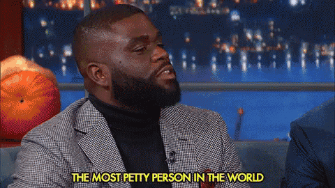 a man in a suit and turtleneck is talking about being the most petty person in the world
