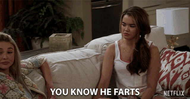 two women sit on a couch and one says you know he farts
