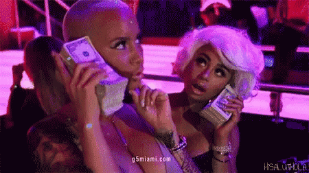 two women are holding stacks of money in front of their faces and the website g5miami.com is visible in the corner