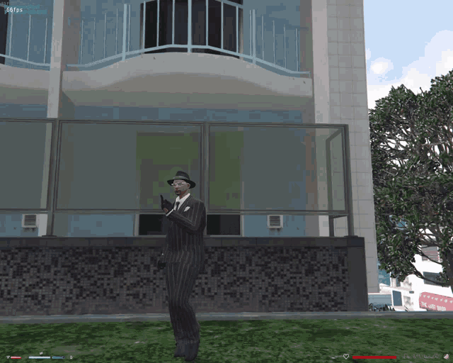 a man in a suit and hat is holding a gun in front of a building with a screen that says 16951 on it