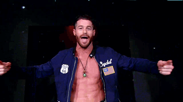 a shirtless man wearing a blue jacket with the word sydal on it