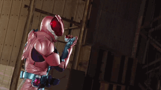 a person in a pink and purple costume with a red helmet