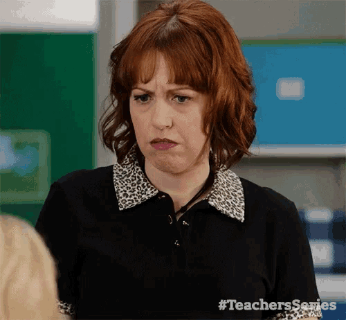 a woman with red hair is wearing a leopard print polo shirt and making a funny face .