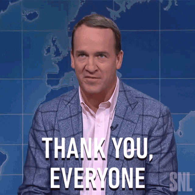 a man in a suit says thank you everyone in front of a map