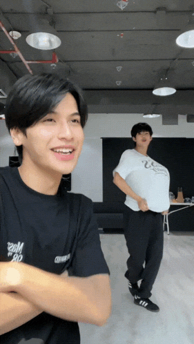 a man wearing a black shirt that says boom boom