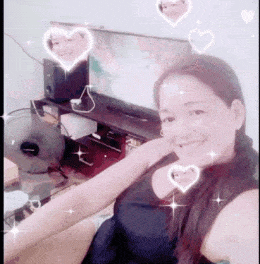 a woman is sitting in front of a television and smiling