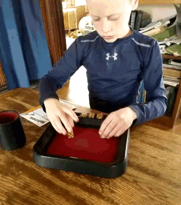 a young boy wearing a blue under armour shirt playing a game